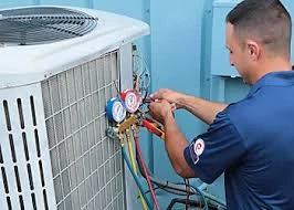 Technician connecting pressure gauges to an outdoor air conditioner