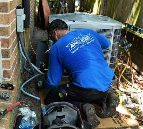 HVAC technician performing repairs beside a residential outdoor condenser
